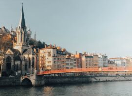 brown concrete building near river during daytime